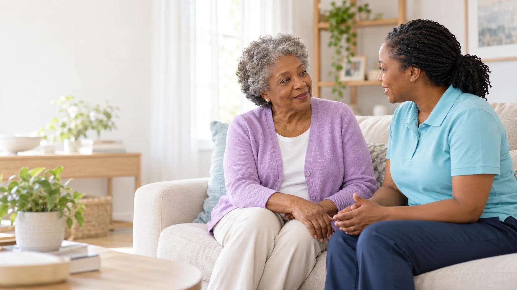 An older woman and a caregiver enjoying a relaxed conversation at home